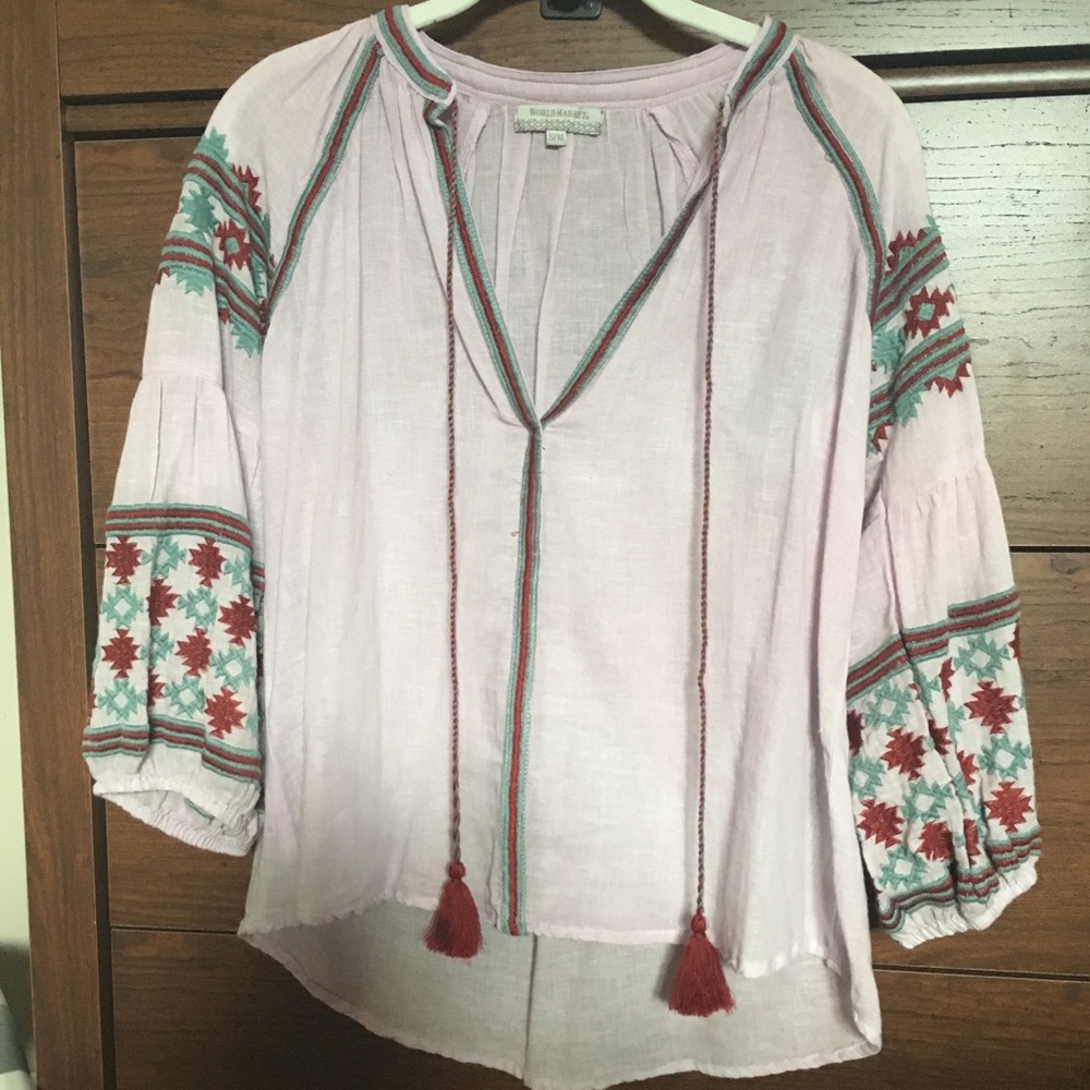 Light purple top with embroidery.